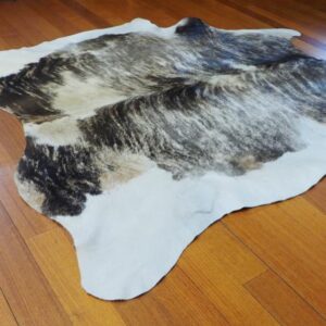 Sandstone Tones grace the rump and break the Grey Wave that covers this Beautiful Cowhide Rug