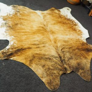A Beautiful Brindled Wave over a Warm Honey Base - Framed with White - A Beautiful Cowhide Rug
