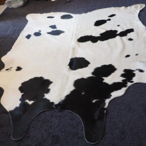 A Lovely Soft White Winter Coat with a Black InkSpot Design Courtesy of Mother Nature - A Beautiful Hand Selected Cowhide Rug