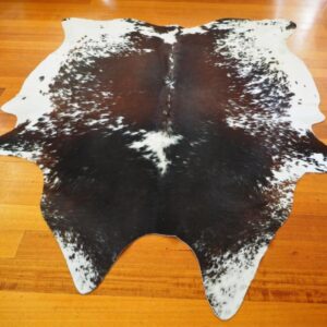 A Beautiful Speckled Red and Black over White Cowhide Rug