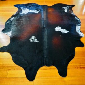A Striking Deep Red Framed In Black - A Beautifully Marked Tri Coloured Cowhide Rug