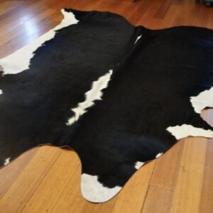 A Classic Hide - A Beautiful Crisp White Frames this Lovely Black Cowhide Rug