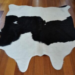 A Lovely Banded Black and White Apartment Sized Cowhide Rug