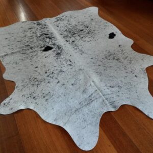 A Beautiful Light Peppering over A Soft White Base - A Lovely Smaller Sized Cowhide - Great for that Cosy Nook or Smaller Room