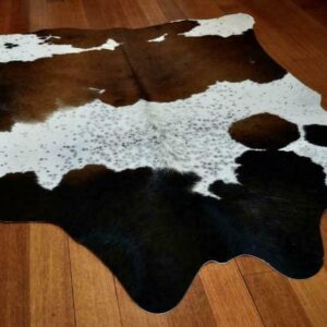 A Beautiful Banded Tri Coloured Cowhide Rug