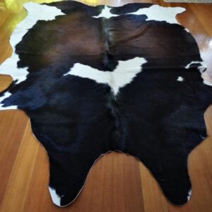 An Eagle Flies Across the Centre of this Glorious Tri Coloured Cowhide Rug