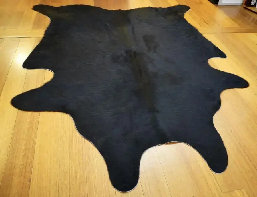 A Neat and Compact Jet Black Aberdeen Angus Cowhide Rug