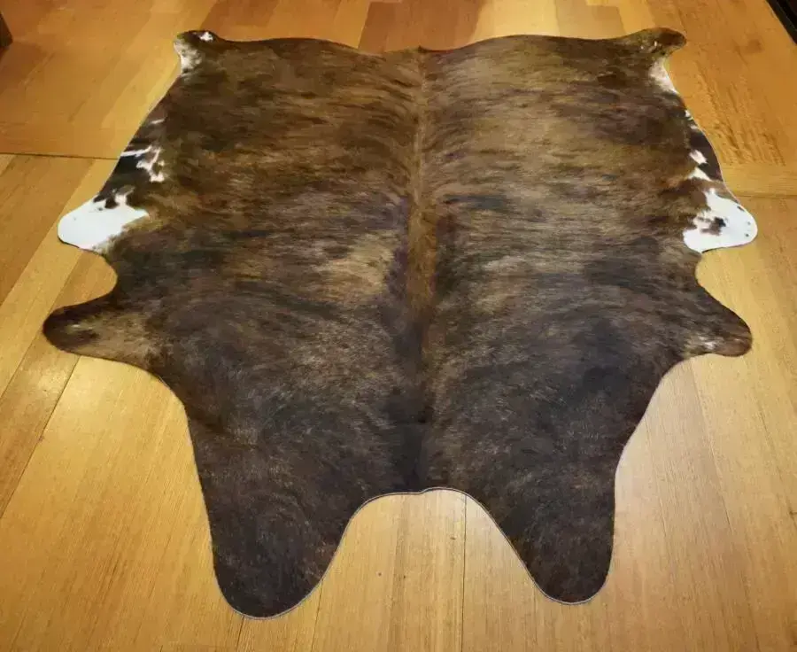 A Beautiful Exotic Wave Highlights this Mid Sized Tri Coloured Cowhide Rug